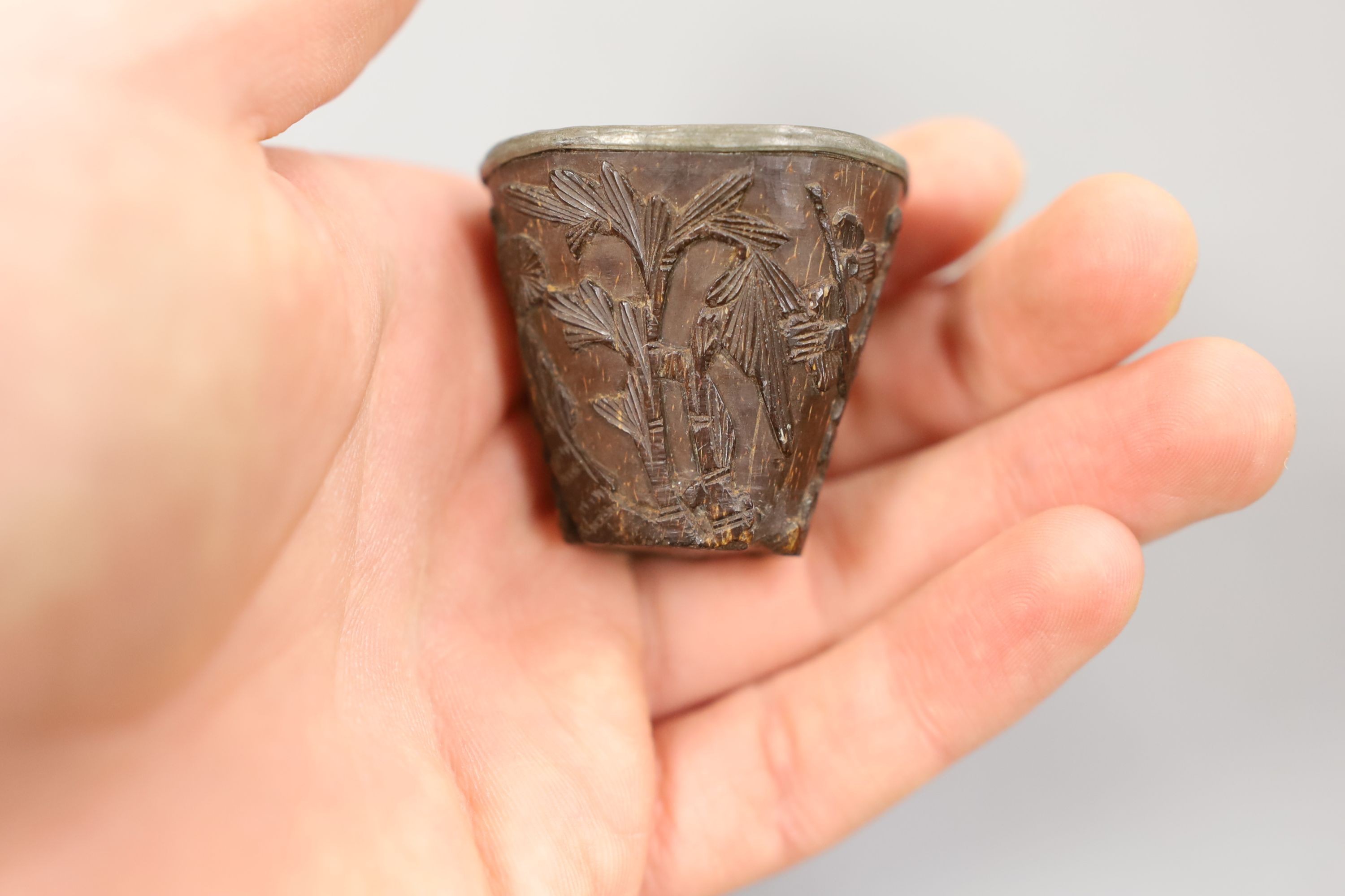 A Chinese or Japanese ivory lion dog 18th/19th century and a Chinese carved nut cup, 19th century. 4cm